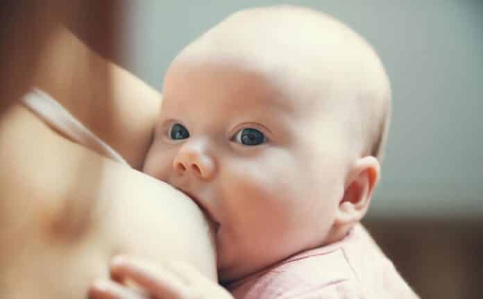 Mother breastfeeding newborn baby child
